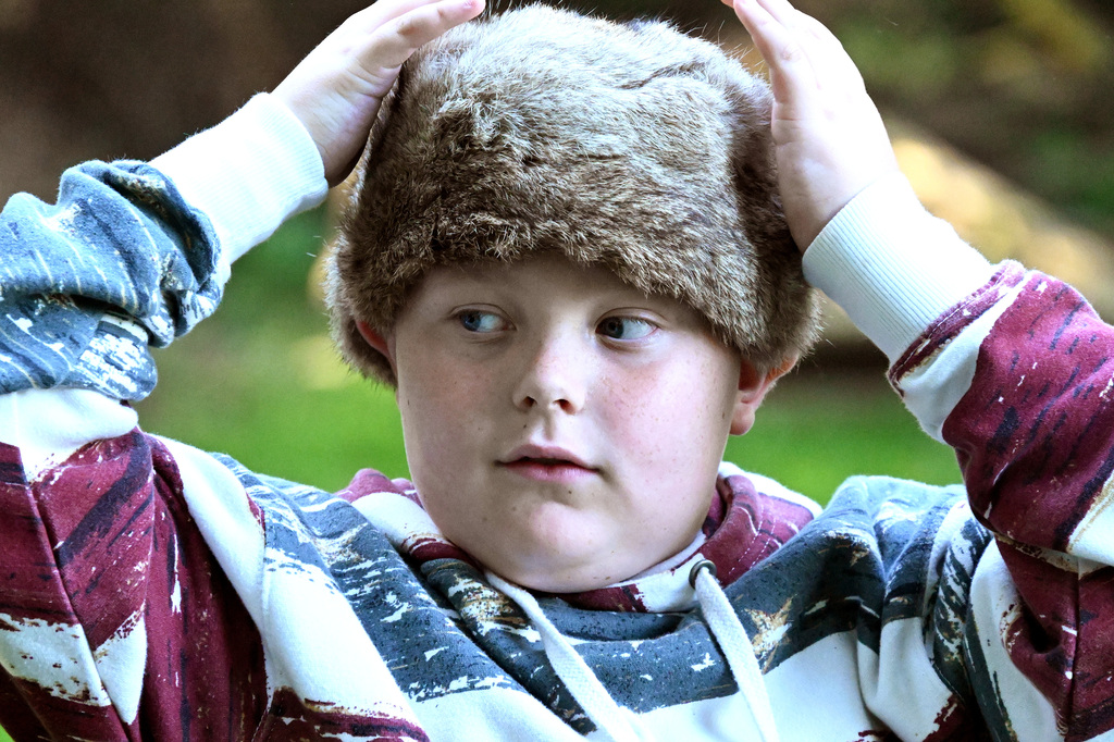 a boy in a coon skin cap