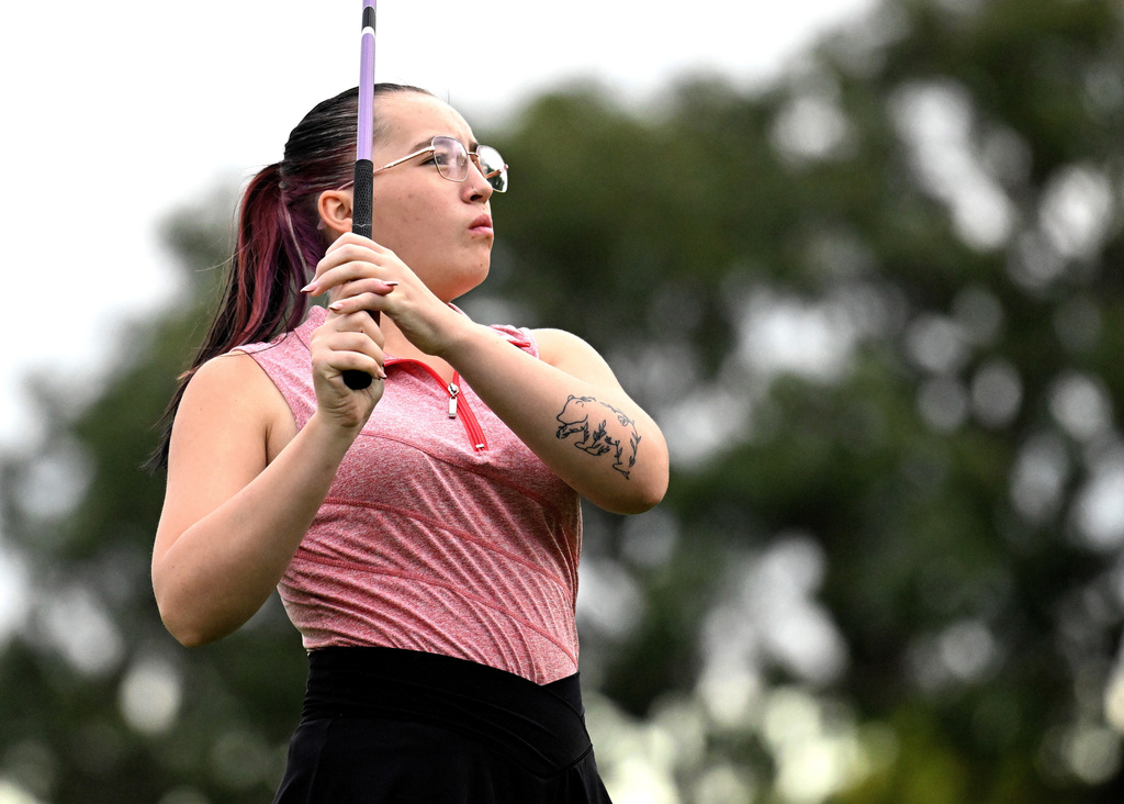 girl watching her golf shot