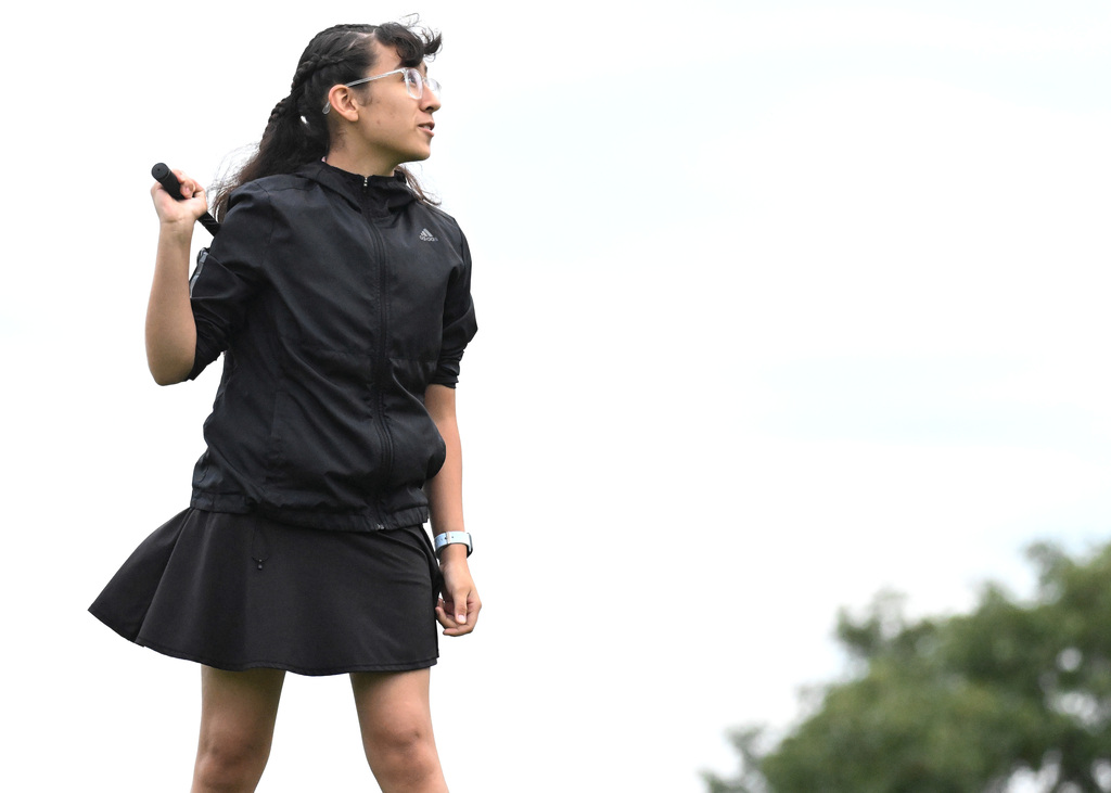 girl watching her golf shot