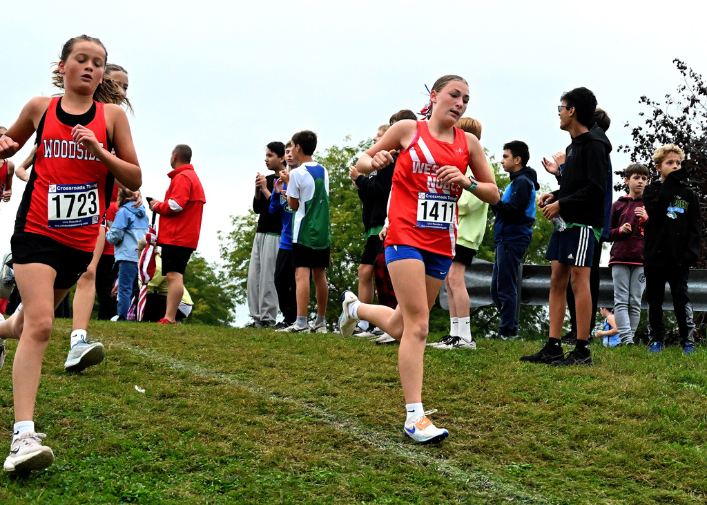 girl in blue and red running a race