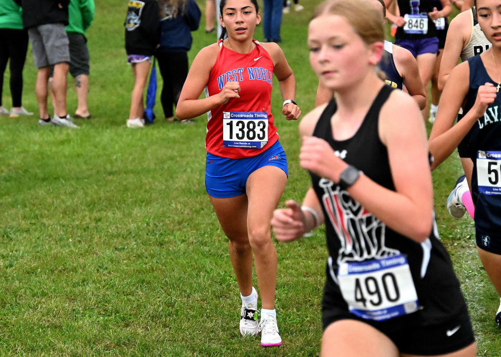 girl in blue and red running a race