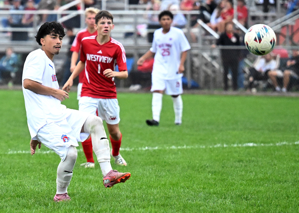 a soccer player kicking a ball
