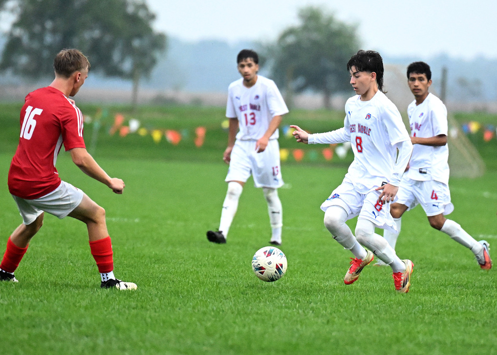 a soccer player dribbling a ball
