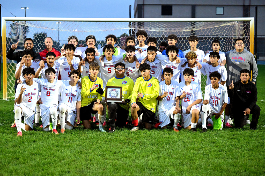 a soccer team posing with a trophy