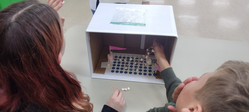 two students talking about a box
