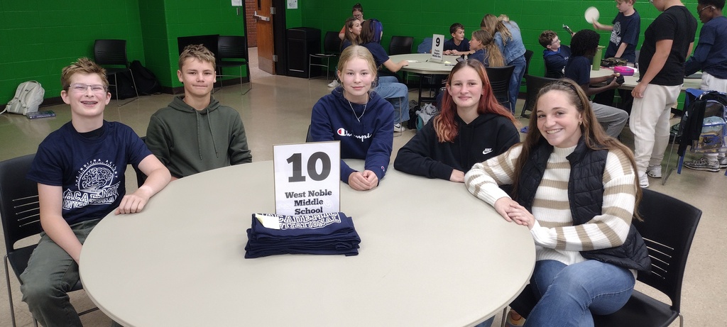 five students sitting at a table