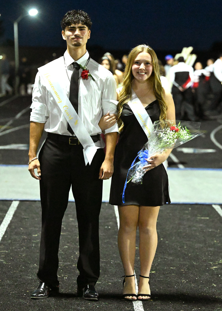 two people posing for homecoming