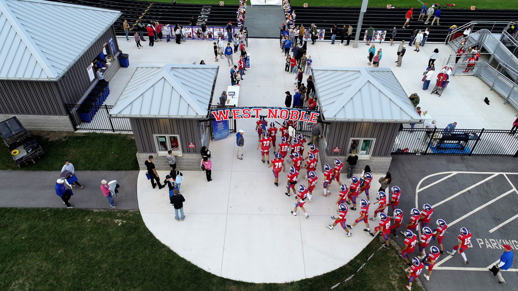 football players entering the stadium