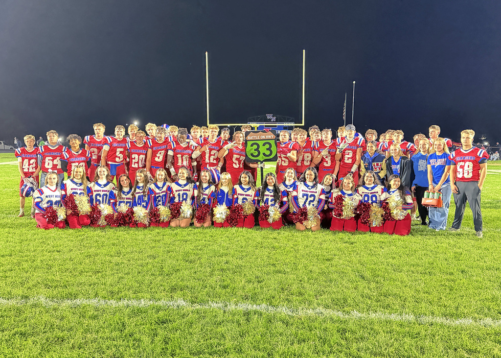 a football team posing with a 33 sign