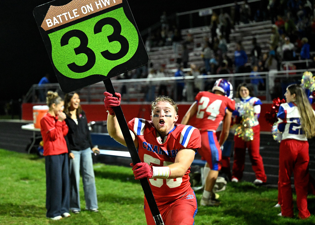 a football player carrying a sign with a 33 on it