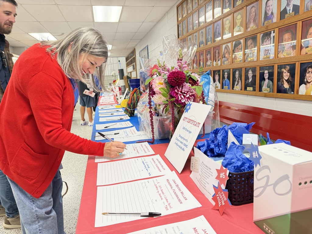a woman bidding on a silent auction item