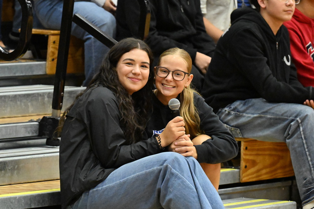two girls talking on a microphone