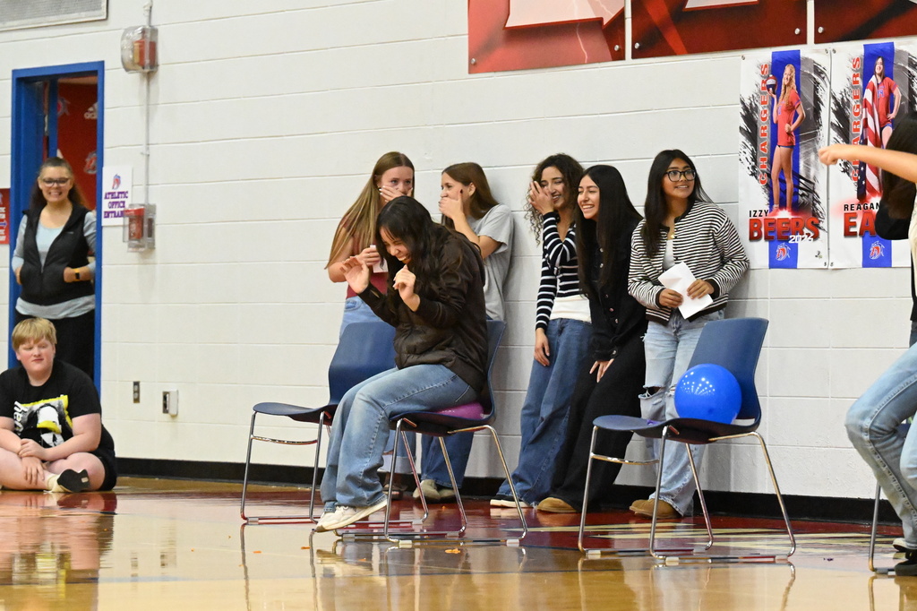 a girl sitting on a balloon with five girls behind laughing
