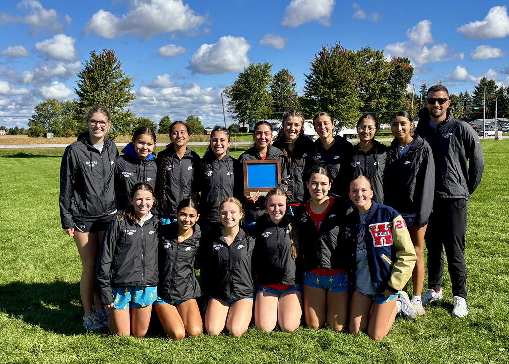 a team of girls holding a trophy