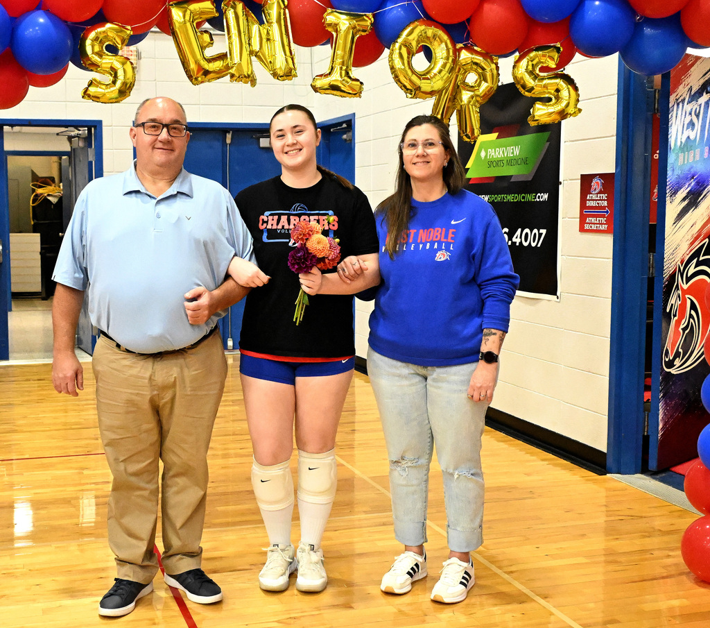 a volleyball player with her parents