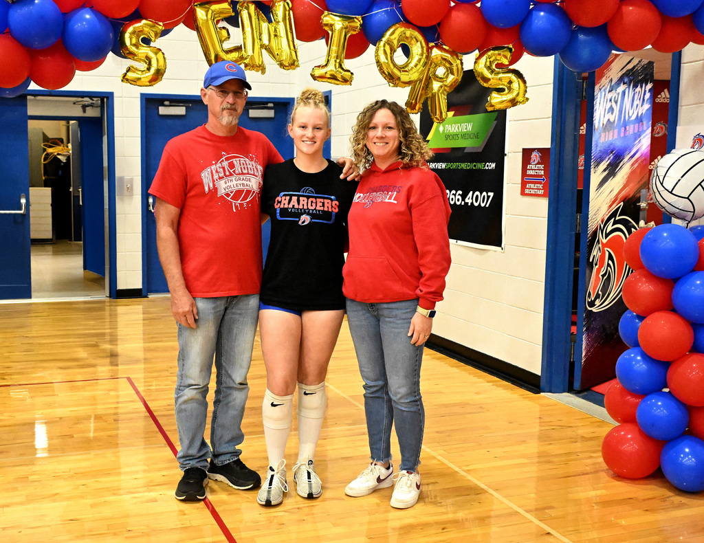 a volleyball player with her parents