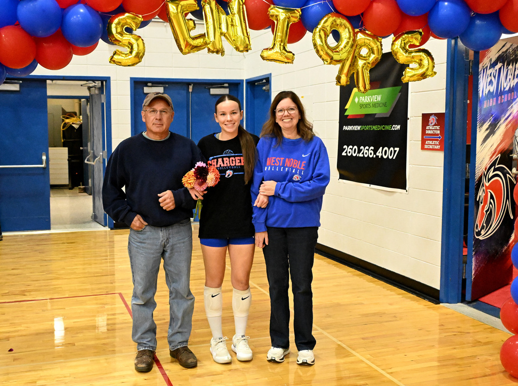 a volleyball player with her parents