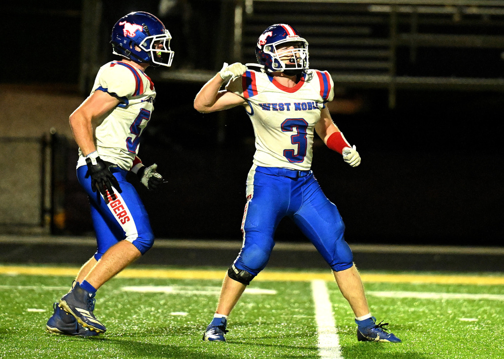 a football player celebrating with his teammate