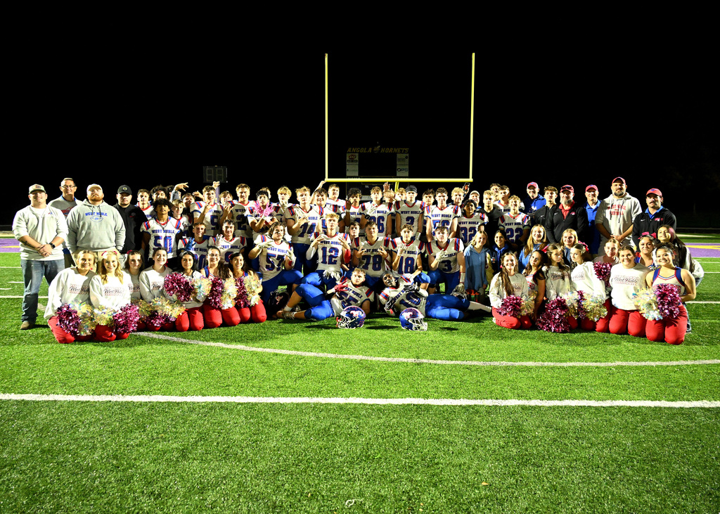 a football team posing after a win