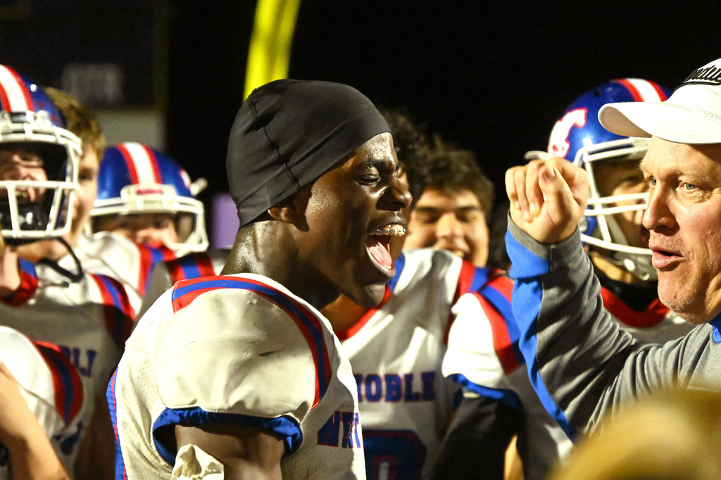 football players celebrating with their teammates and coaches