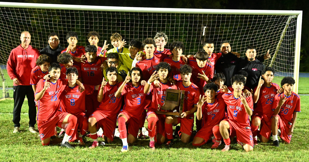 soccer team posing with a trophy
