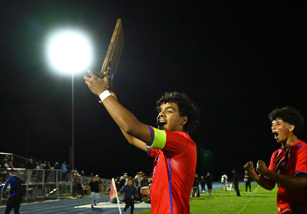 soccer player holding a trophy