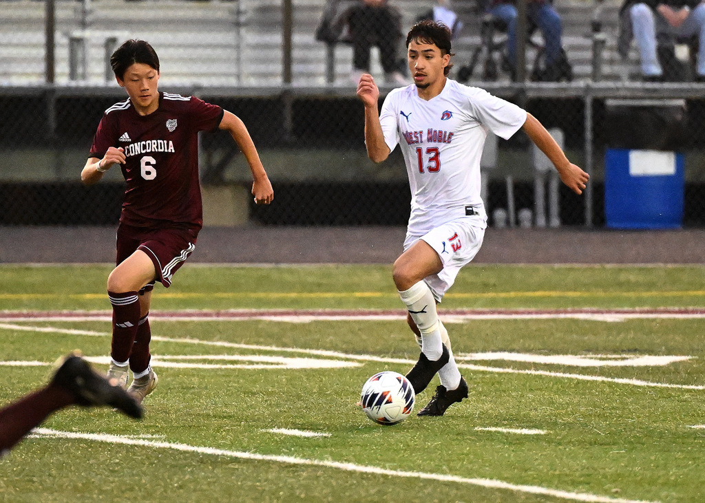 two boys playing soccer