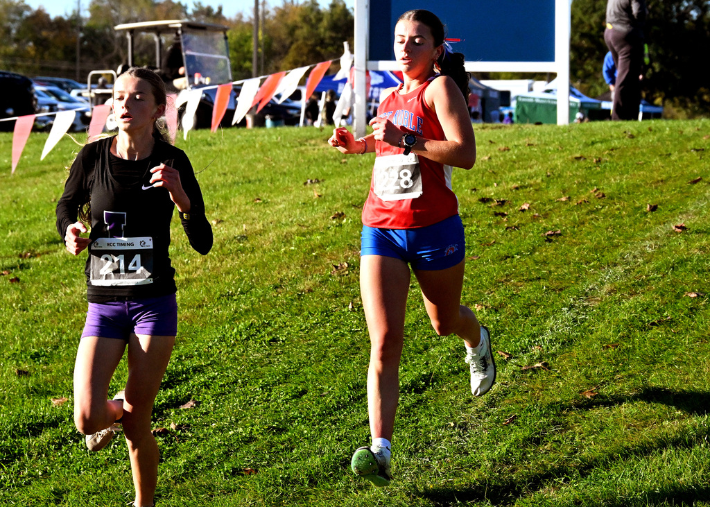 girls running on a cross country course