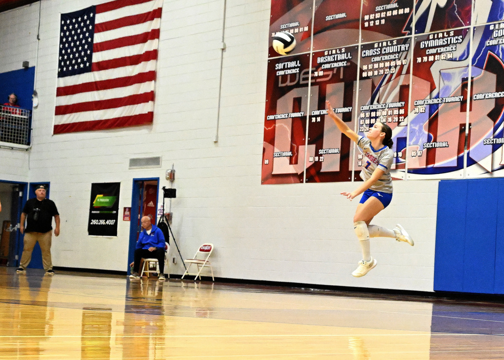 a girl hitting a volleyball