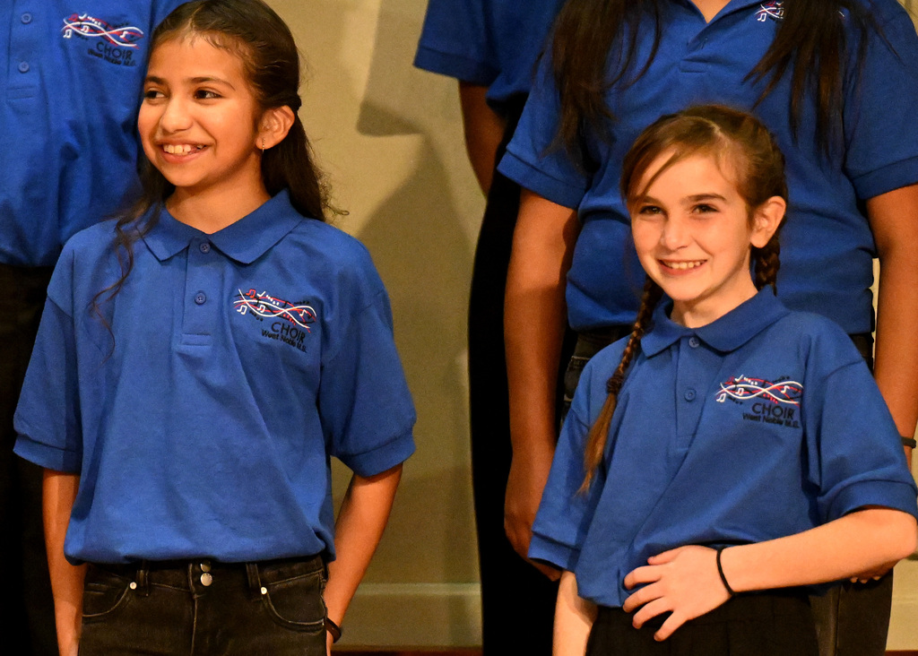 two choir members smiling