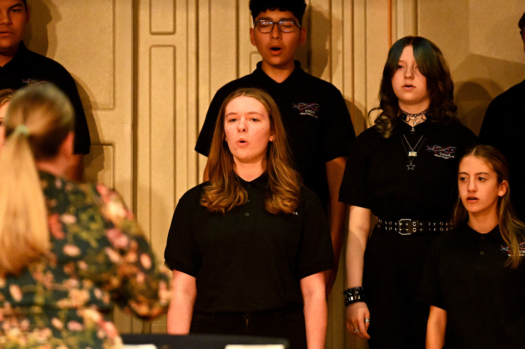 four people singing in the choir
