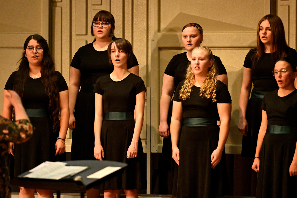 seven people singing in the choir