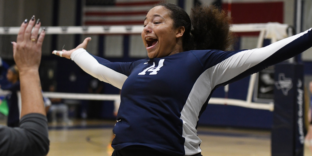 WOS Volleyball player celebrating after play