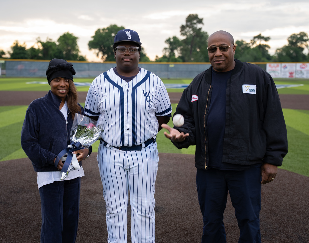 WOS senior standing with their family for baseball senior night
