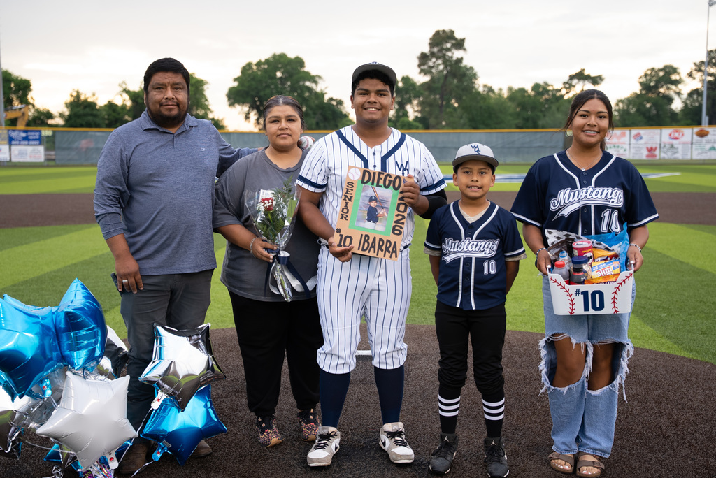 WOS senior standing with their family for baseball senior night