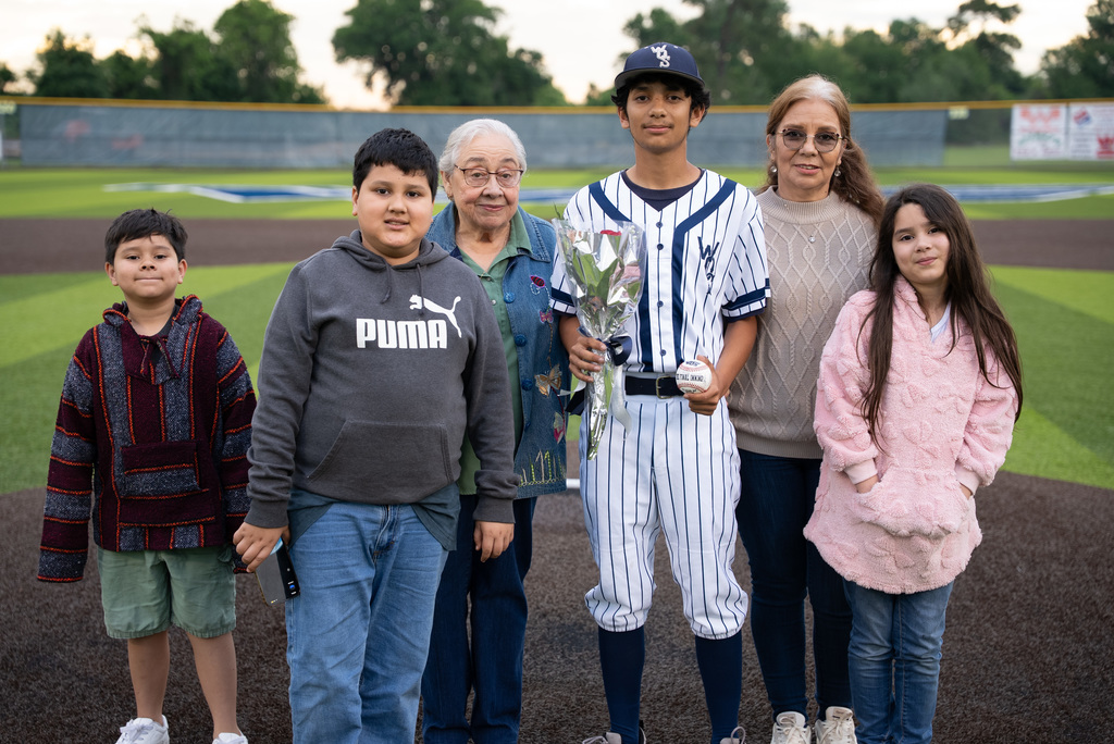 WOS senior standing with their family for baseball senior night