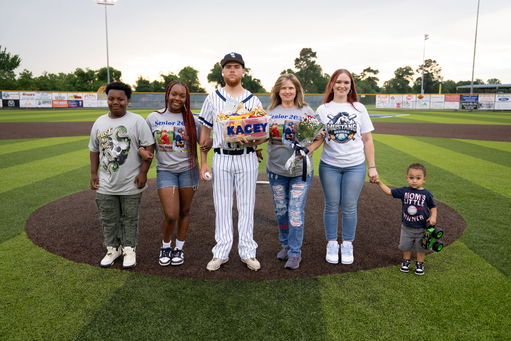 WOS senior standing with their family for baseball senior night