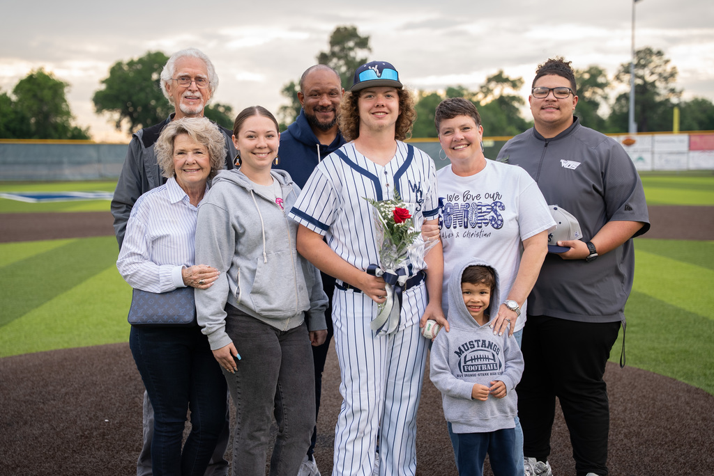 WOS senior standing with their family for baseball senior night