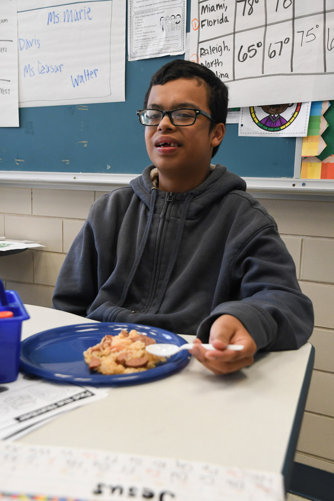 student enjoying a plate of jambalaya