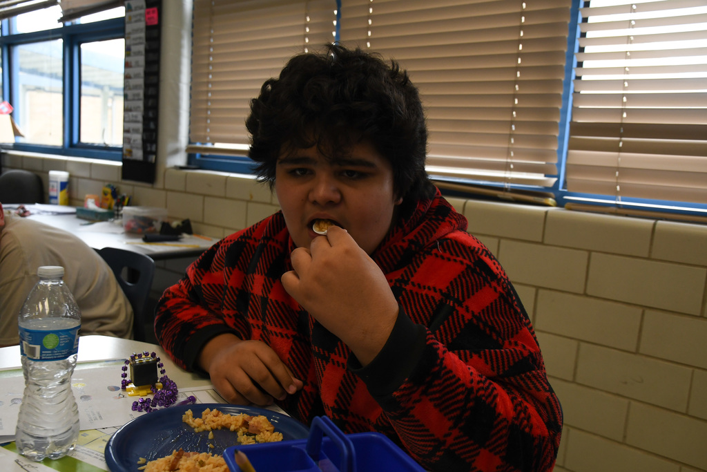 student enjoying a plate of jambalaya
