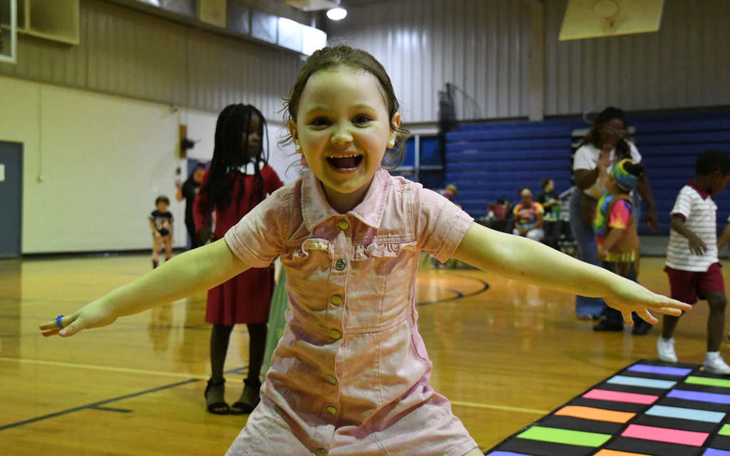 girl with a big smile in the middle of dacning