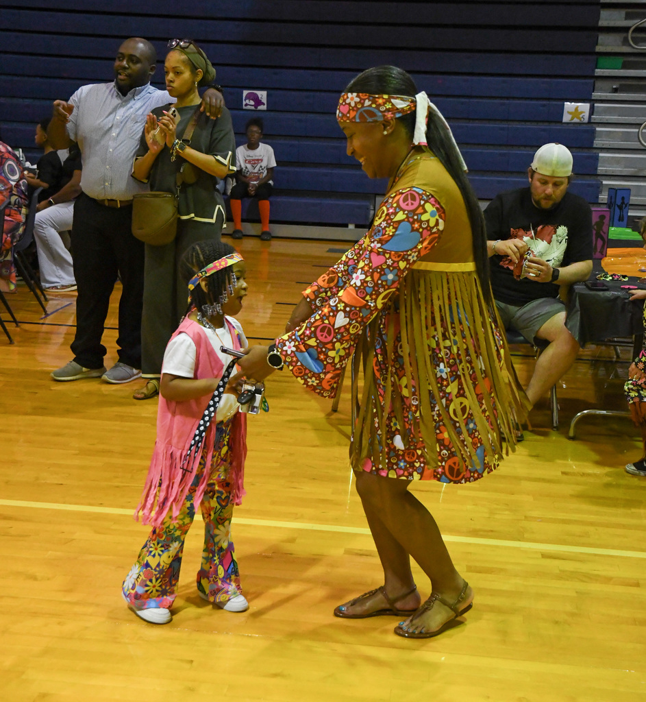 adult and child dancing in disco attire
