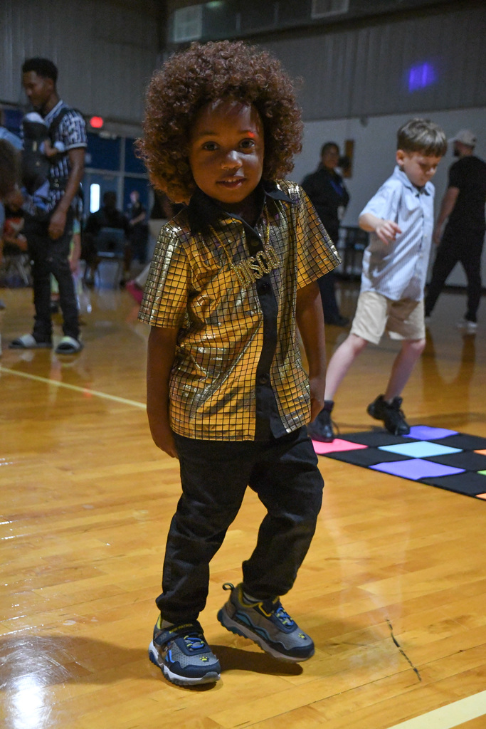 kid in disco attire at a dance
