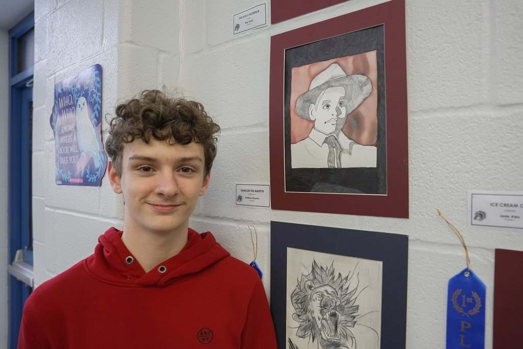 students presenting artwork at WOSMS art show