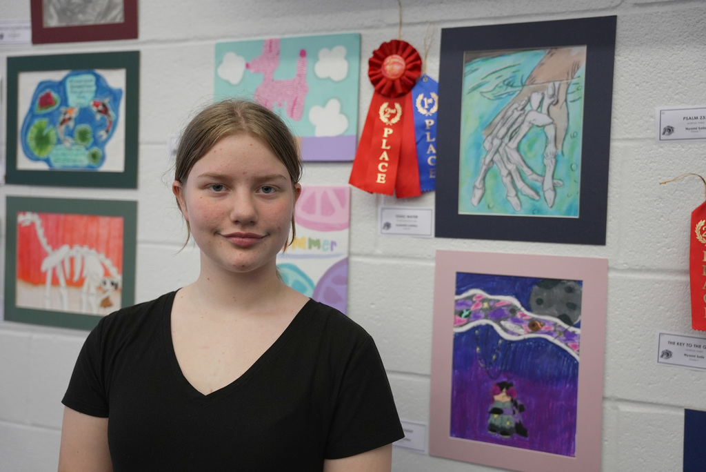 students presenting artwork at WOSMS art show