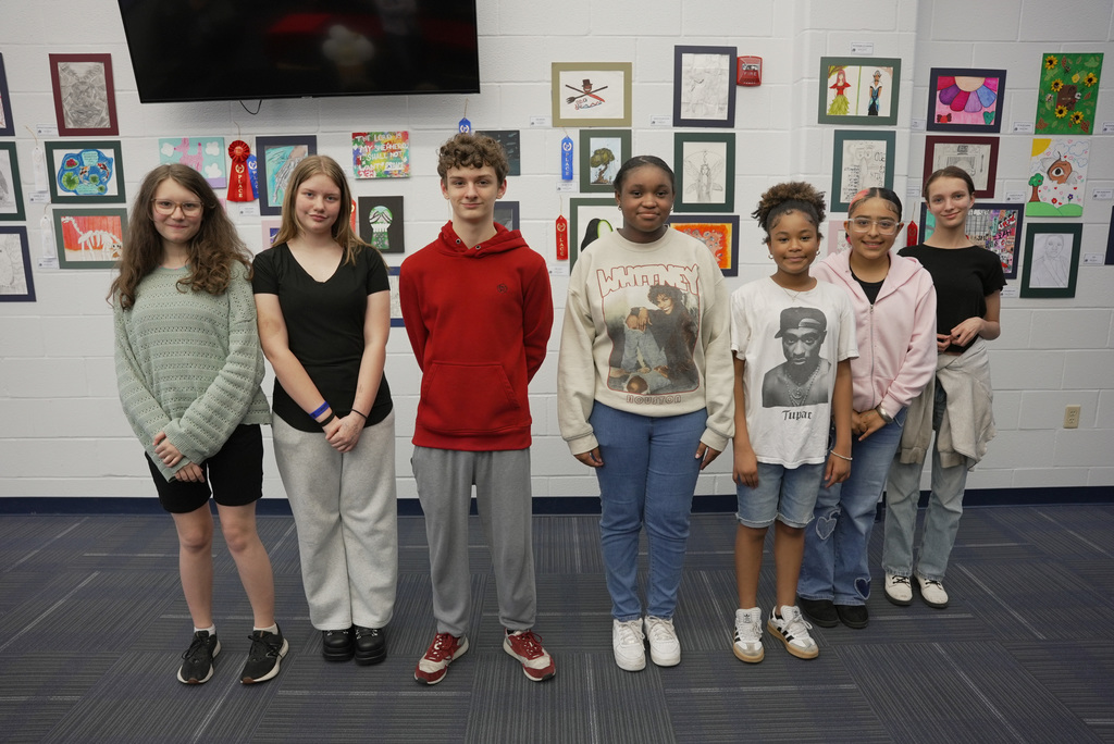 students presenting artwork at WOSMS art show