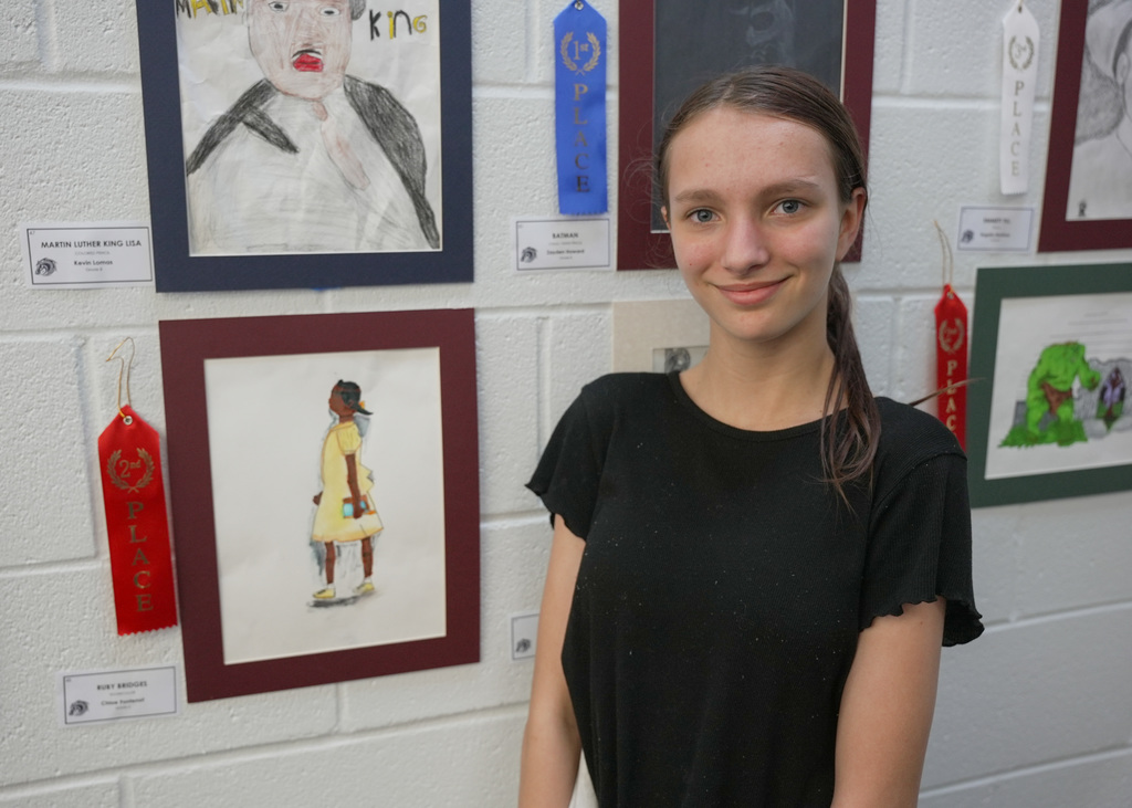 students presenting artwork at WOSMS art show