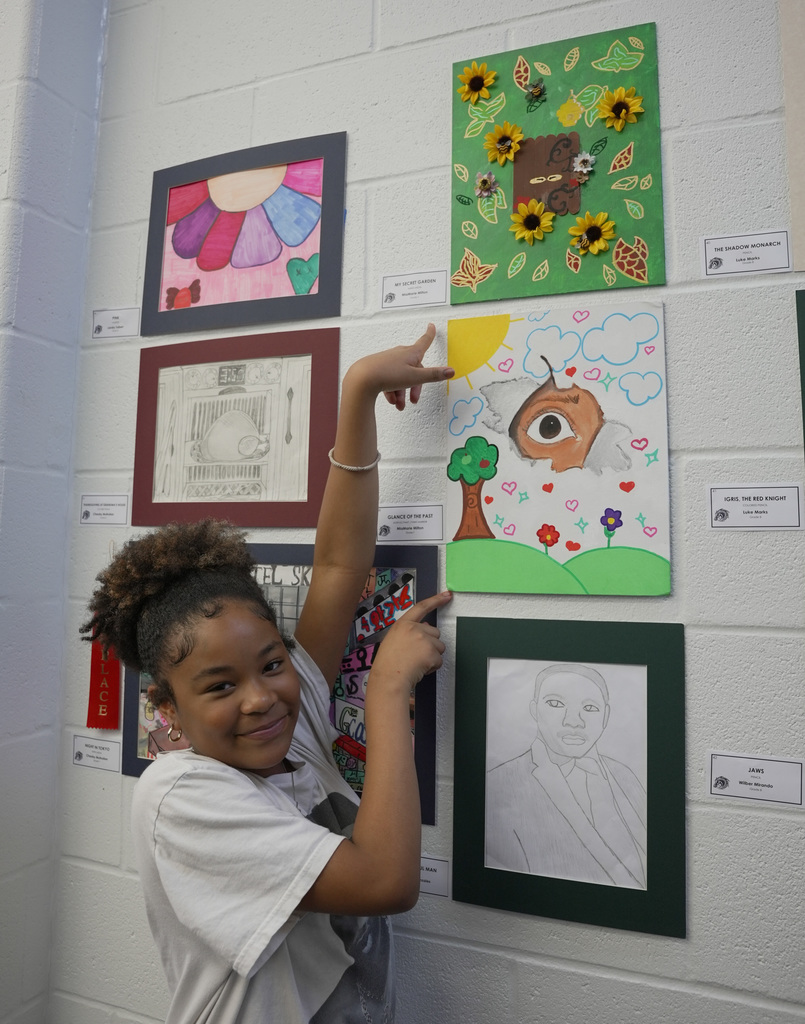 students presenting artwork at WOSMS art show