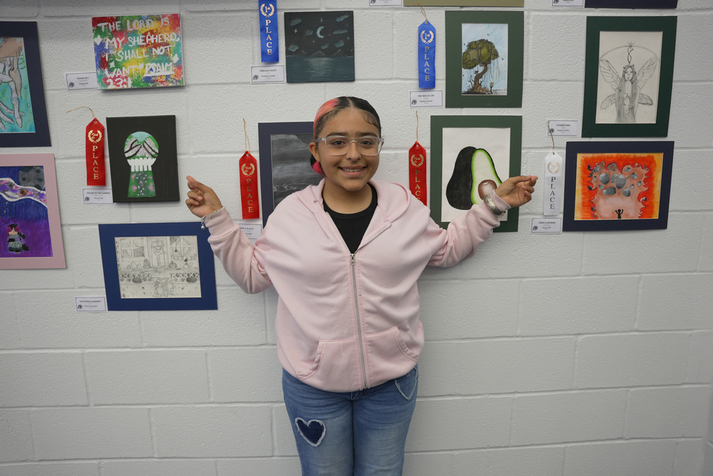 students presenting artwork at WOSMS art show