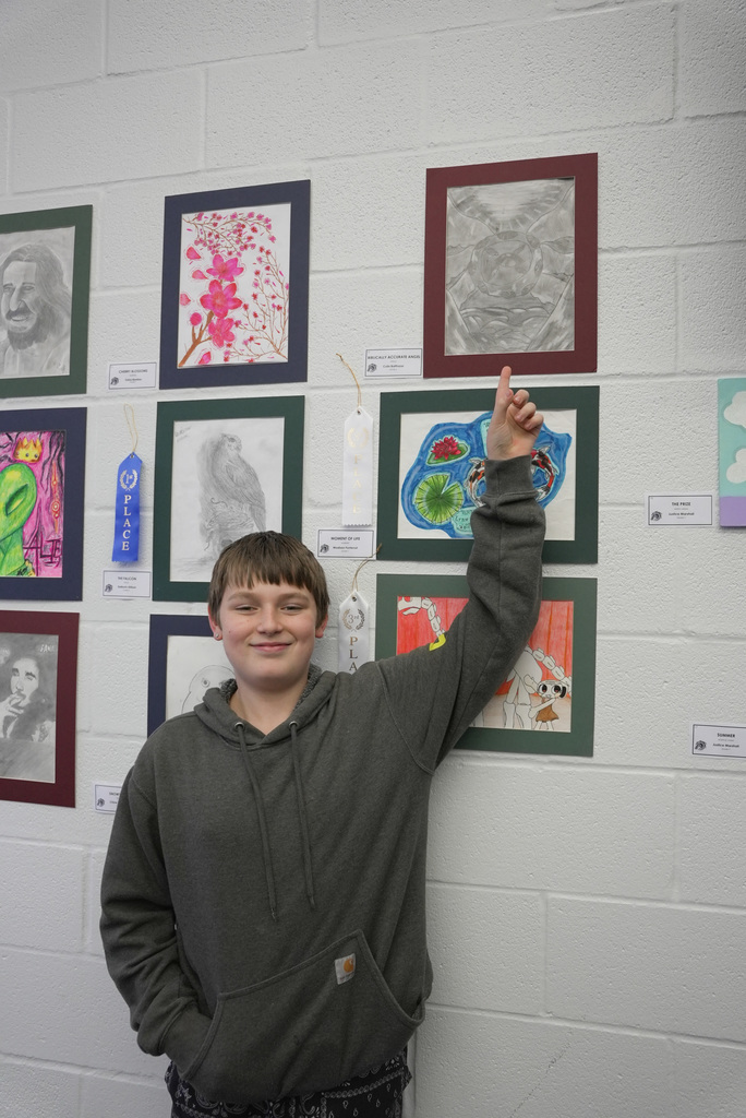 students presenting artwork at WOSMS art show